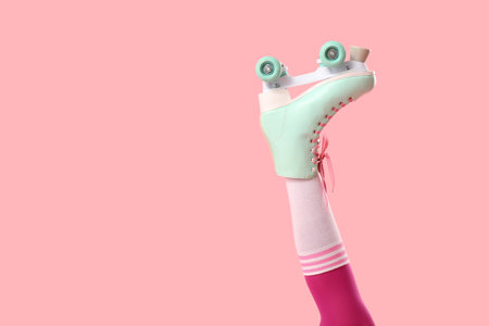 Leg of woman in roller skates on pink backgroundの写真素材