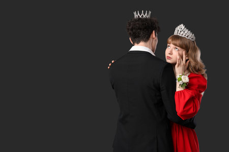 Young girl hugging her prom date and crying on black backgroundの写真素材