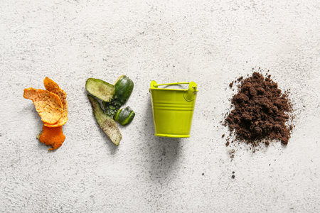 Bucket, organic waste and soil on white grunge background. Compost recycling concept