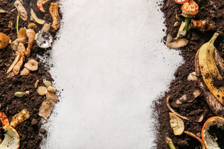 Frame made from organic waste and soil on white grunge background. Compost recycling concept