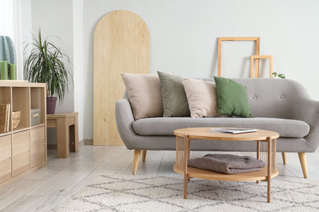 Modern interior of living room with sofa and soft pillowsの写真素材