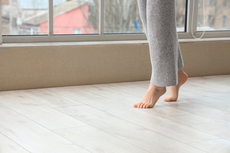 Woman on laminate floor at home, closeupの写真素材