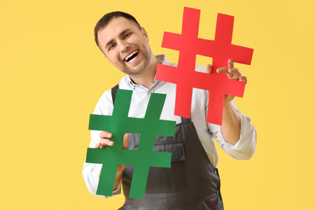 Male gardener with hashtags on yellow backgroundの写真素材