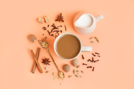 Cup of tasty masala tea with different spices on beige backgroundの写真素材