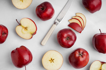 Cut fresh red apples on white backgroundの写真素材