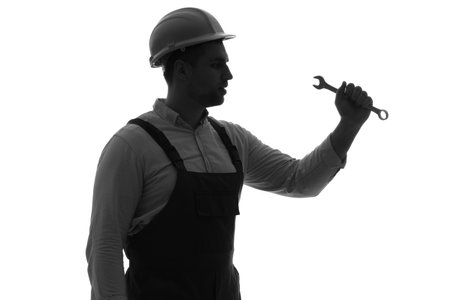 Silhouette of male worker with wrench on white backgroundの写真素材