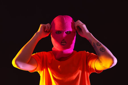 Handsome young man in balaclava on black backgroundの写真素材