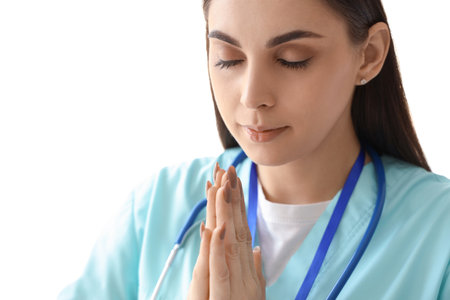 Female nurse praying in clinic, closeupの写真素材