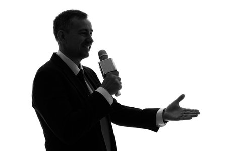 Silhouette of mature journalist with microphone on white backgroundの写真素材