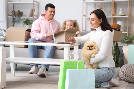 Happy family with dog shopping online at homeの写真素材
