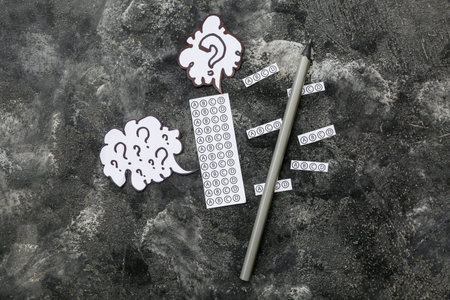 Quiz form and speech bubbles with question marks on grunge black background