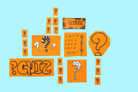 Paper quiz cards and question marks on blue backgroundの写真素材