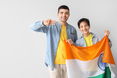 Little boy with his father and Indian flag on light backgroundの写真素材