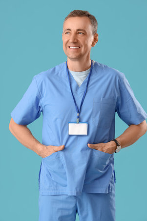 Mature doctor in medical uniform on blue backgroundの写真素材