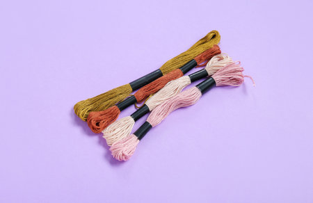 Different colorful mouline threads on lilac backgroundの写真素材