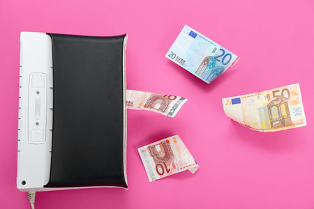 Air purifier with euro banknotes on pink backgroundの写真素材