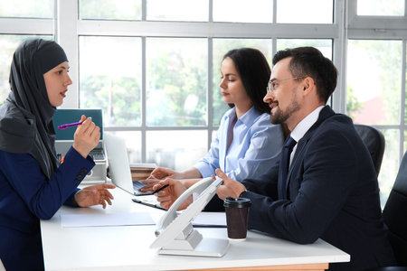 Human resources commission interviewing Muslim applicant in office