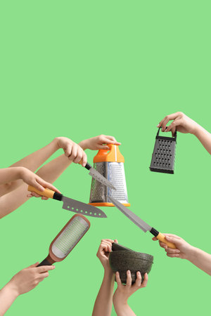 Women with kitchen utensils on green backgroundの写真素材