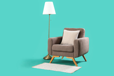 Cozy armchair with standard lamp on turquoise backgroundの写真素材
