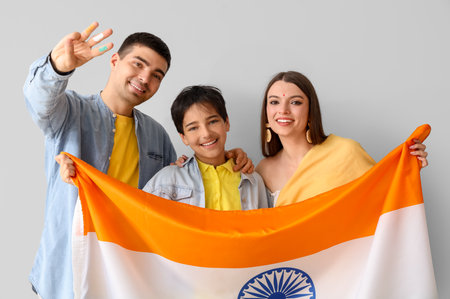Happy family with Indian flag on light backgroundの写真素材