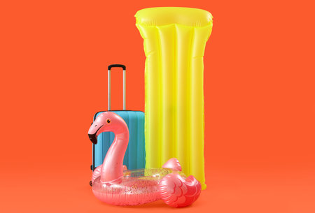 Inflatable ring, swimming mattress and suitcase on orange background. Travel conceptの写真素材