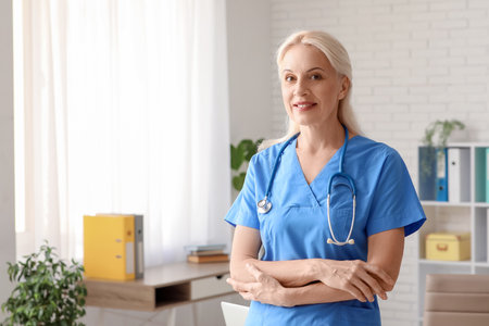 Portrait of mature female doctor in clinicの写真素材