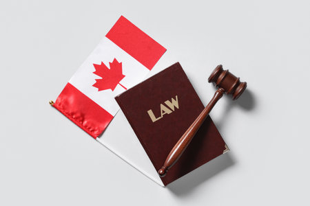 Judge's gavel, Law book and Canadian flag on light backgroundの写真素材