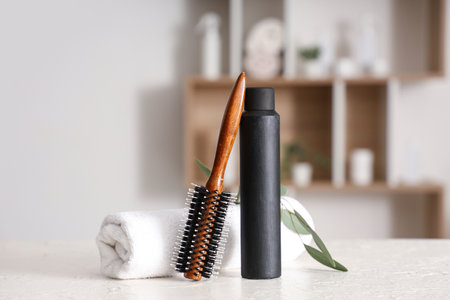 Hair spray with brush and towel on table in beauty salonの写真素材