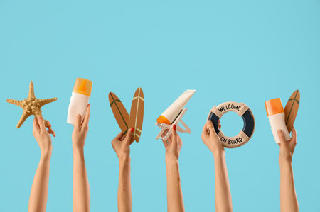 Female hands with beach items on blue backgroundの写真素材