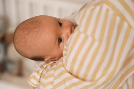 Mother breastfeeding her baby in bedroom, closeupの写真素材