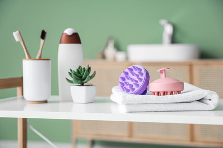 Hair scalp massagers with bath accessories on shelf in room, closeup