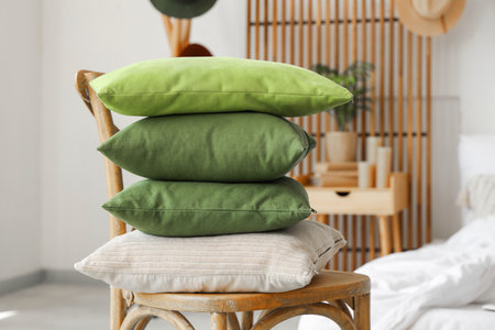 Chair with stack of pillows in light bedroom, closeupの写真素材