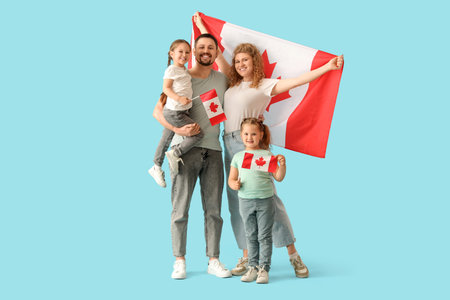Happy beautiful family with flags of Canada on blue background