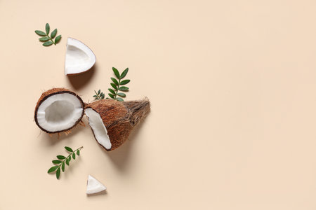 Fresh coconuts and leaves on beige backgroundの写真素材