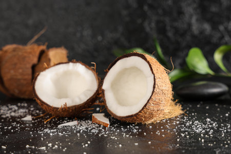 Halves of fresh coconut on black backgroundの写真素材