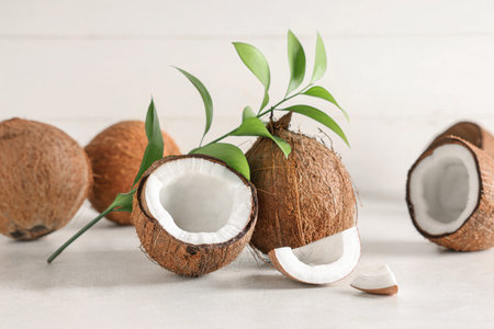 Fresh coconuts and leaves on white table