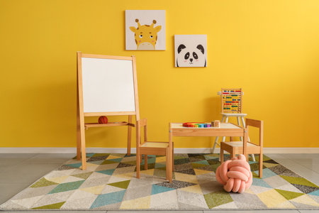 Interior of playroom with toys and whiteboard in kindergartenの写真素材