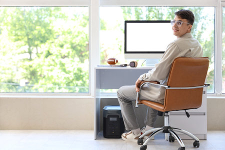 Young man sitting near desk at homeの写真素材