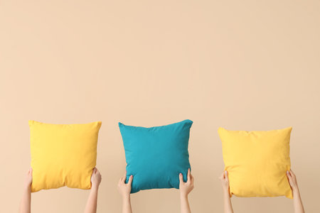 Women with bright pillows on beige background