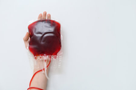 Female hand with blood pack on white background. World Blood Donor Dayの写真素材
