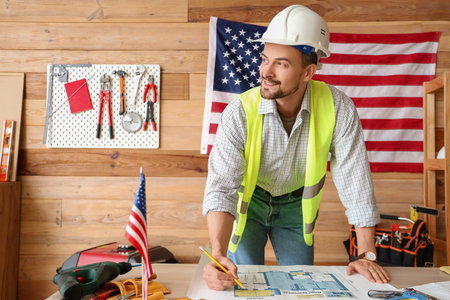 Male architect working with house plan in workshop. Labor Day celebrationの写真素材
