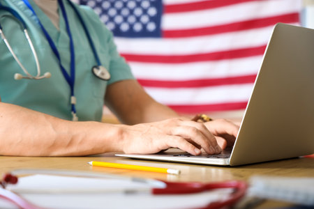 Male doctor working with laptop in clinic, closeup. Labor Day celebrationの写真素材