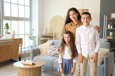 Happy Jewish mother hugging her little children at homeの写真素材