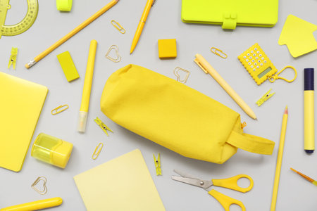 Pencil case and different stationery on gray backgroundの写真素材