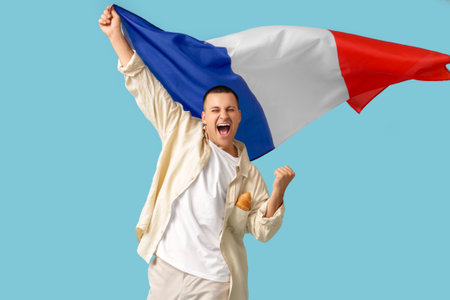 Happy young man with flag of France on blue backgroundの写真素材