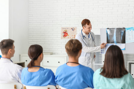 Group of young doctors studying x-ray scan of lungs in clinicの写真素材