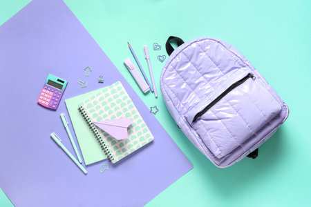 School backpack and different stationery on color backgroundの写真素材