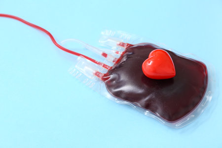 Blood pack with heart on blue background. World Blood Donor Dayの写真素材