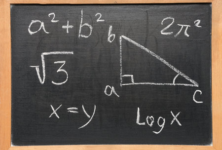 Drawn triangle and math formulas on black chalkboard