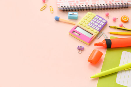 School supplies with calculator, marker and copybook on beige background. Top view